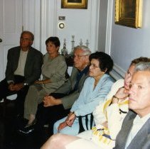 People listening to presenttion at someone's home