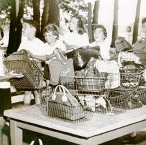 Campers putting their lunch bags in wire baskets
