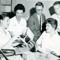 Shirley Natkow and four others examining popsicle stick structures