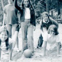 Five girls playing "wheelbarrow" on the beach