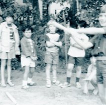 Child taking and others preparing for batting practice