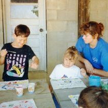 Ryan Schuster and Flynne Weingarten painting at a table
