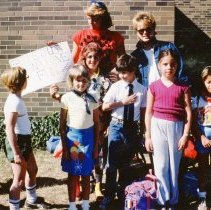 Campers and counselors posing outdoors with "Girls Just Wanna Have Fun" sig