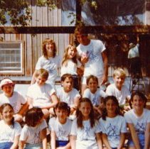 Campers and counselors posing at picnic table