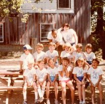 Campers and counselors posing at picnic table