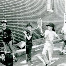 Campers posing with tennis rackets outside Temple Beth-El