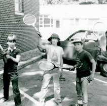 Campers with wooden tennis rackets outside Temple Beth-El