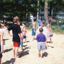 Children with ball on beach.