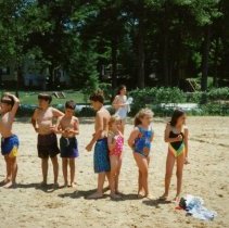 Campers standing on beach with balls.