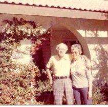 Man and woman standing in front of home