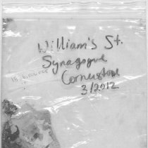 Photograph of bag containing fragments of synogogue building