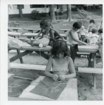 Camper making art with yarn