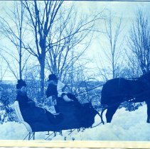Marjorie Gray in sleigh with her grandfather and mother