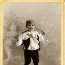 Young boy holding a whip