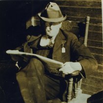 Nathan Robbins reading the paper after a hard day's work