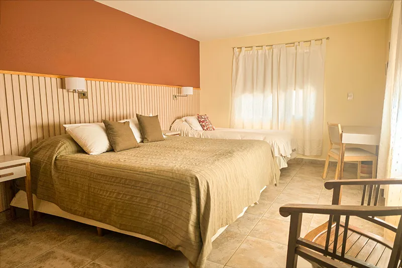 A triple bedroom at Lunajuim Hotel in El Chaltén