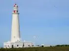 The Cabo de Santa María Lighthouse is located on the coast of the Atlantic Ocean, in La Paloma, Rocha