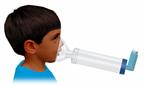 A child using a respiratory inhaler with spacer and mask.