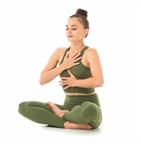 An adult doing mindful breathing while practicing yoga.