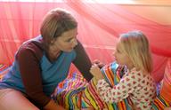 An adult talking to a young child.