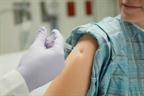 A person receiving a shot in the upper arm.