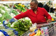 A person shopping for fresh vegetables at the grocery store.