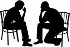 A teen talking with an adult.