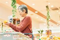 An adult shopping for fresh fruit.