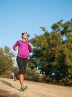 A pregnant person running.