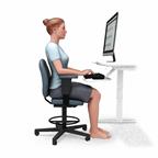 A person showing good posture while sitting at a desk and using a computer.