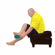 Barefoot person sitting with right leg crossed over left, using handheld mirror to see bottom of right foot.