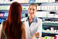 A pharmacist speaking with a customer at the pharmacy.