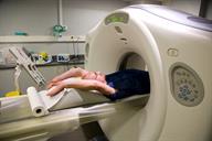 A CT scanner with a person lying down for images to be taken.