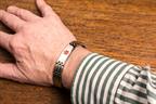 A medical alert bracelet on a person's wrist.