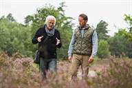 Two people walking outdoors. 