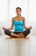A pregnant person doing yoga.