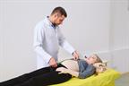 A pregnant woman being examined by a health care provider.