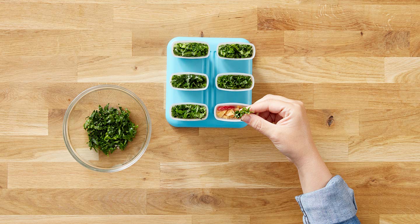Cut the kale leaf into ribbons and top each mold with the garnish.