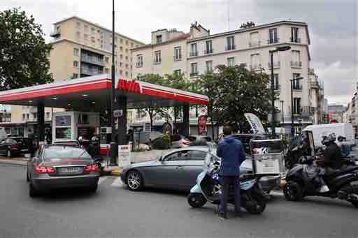 Drivers queue to buy gas in a station, in Paris, Tuesday, May 24, 2016. A two-month protest movement against a bill weakening France's famed worker protections reached a new level this week as fuel industry workers joined in. Strikes have spread to all eight of France's refineries, and one in five gas stations are now dry or running low. (AP Photo/Thibault Camus)