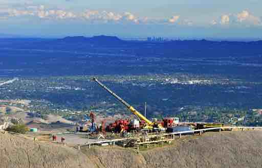 FILE - In this Nov. 3, 2015, file photo, provided by Southern California Gas Co., SoCalGas crews and technical experts attempt to safely stop the flow of natural gas leaking from a storage well at the utility’s Aliso Canyon facility near the Northridge section of Los Angeles. Sempra Energy says costs from a massive gas leak in Los Angeles have reached $665 million. In an SEC filing in February, SoCalGas, which is owned by Sempra, estimated costs of less than half that, $250 million to $300 million. The massive gas leak that spewed uncontrollably for nearly four months drove thousands of Los Angeles residents to leave their homes. It was capped in late February. (Javier Mendoza/SoCalGas via AP, File)