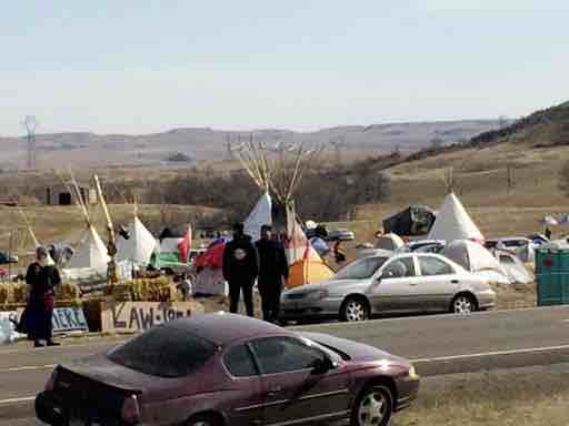 Teepees and numerous tents are set up Monday, Oct. 24, 2016, by Dakota Access oil pipeline protesters in southern North Dakota on property owned by the pipeline company. Protesters say they have treaty rights to the land from the 1800s. (AP Photo/Blake Nicholson)