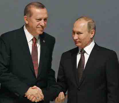 Turkey's President Recep Tayyip Erdogan, left, and Russian President Vladimir Putin, right, shake hands following the group photo at the World Energy Congress. AP photo