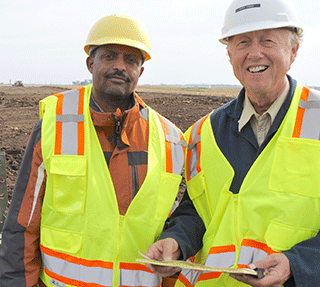 Iowa State University's Mehari Tekeste, left, and Mark Hanna at the experimental site.