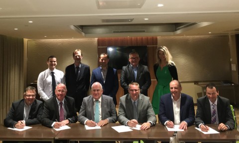 Front row: Phil Buck, Spencer Coatings Group Managing Director (third from left) and Michael Cash, Axalta SVP and President, Industrial Coatings (fourth from left) with other Spencer Coatings Group shareholders, Axalta executives, and guests. Photo courtesy of Axalta Coating Systems.