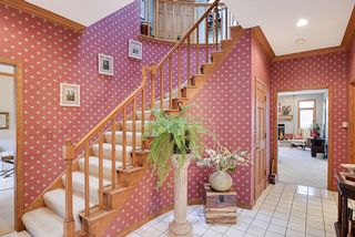Curved staircase leads to spacious upper level with four bedrooms...