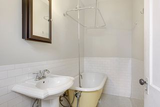 Claw foot tub with shower surround.