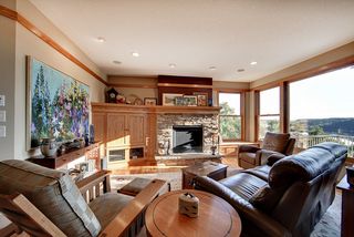 Craftsmen styling throughout with white oak millwork and banding, gas fireplace with stone surround and custom cabinetry.