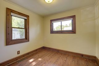 Bedroom 1 - Laminate floors, wood trim accents.