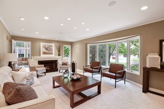 Formal living room with expansive windows, fireplace and inviting seating areas.