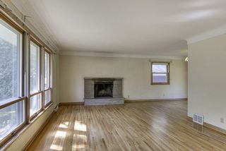 Sun-filled rooms - gleaming hardwood floors - one of two wood burning fireplaces enjoyed in both living and dining...